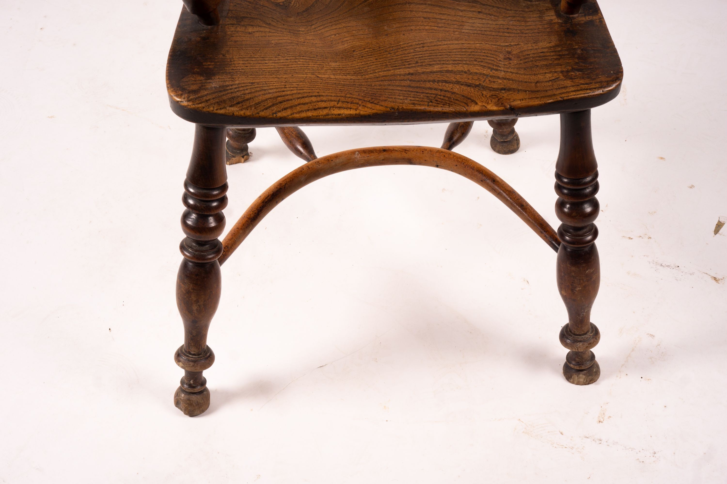 A mid 19th century yew and elm Windsor elbow chair with crinoline stretcher, width 54cm, depth 46cm, height 94cm